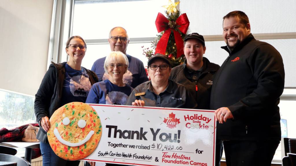 Employees of Tim Hortons and the South Cariboo Health Foundation hold up a cheque for $10,422 on Dec. 5 at the 100 Mile Tim Hortons. The money was split between the South Cariboo Health Foundation was split between the foundation and the Tim Hortons Foundation Camps, which helps pay for disadvantaged youths to go to summer camps. (Misha Mustaqeem photo - 100 Mile Free Press)