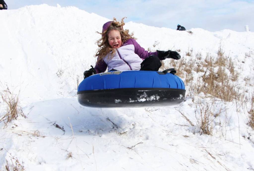 Bella Laslo launches off of a jump while tubing at the 108 Mile Community Association&rsquo;s Family Fun Day on Monday, Feb. 17, 2025. This year the 108 Mile Community Association&rsquo;s Family Fun Day is set to take place on Feb. 16, 2026. (Patrick Davies photo - 100 Mile Free Press)